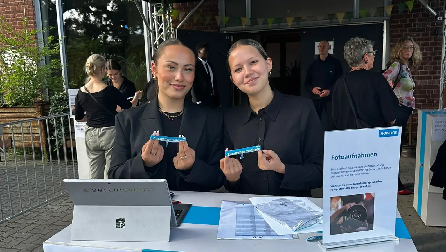 Zwei StaffConnect-Hostessen am Check-in-Tisch mit Laptop und Tickets