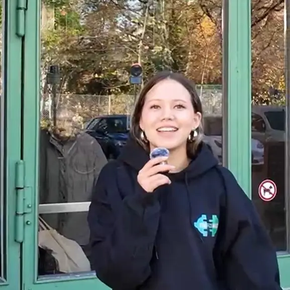 Staff member in a StaffConnect hoodie talking into the camera with a clip-on mic, recording a training video