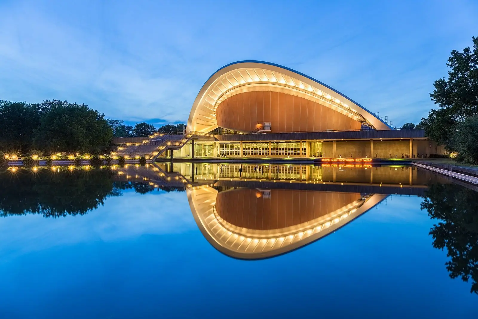 The House of World Cultures in Berlin at blue hour, reflected in the pool